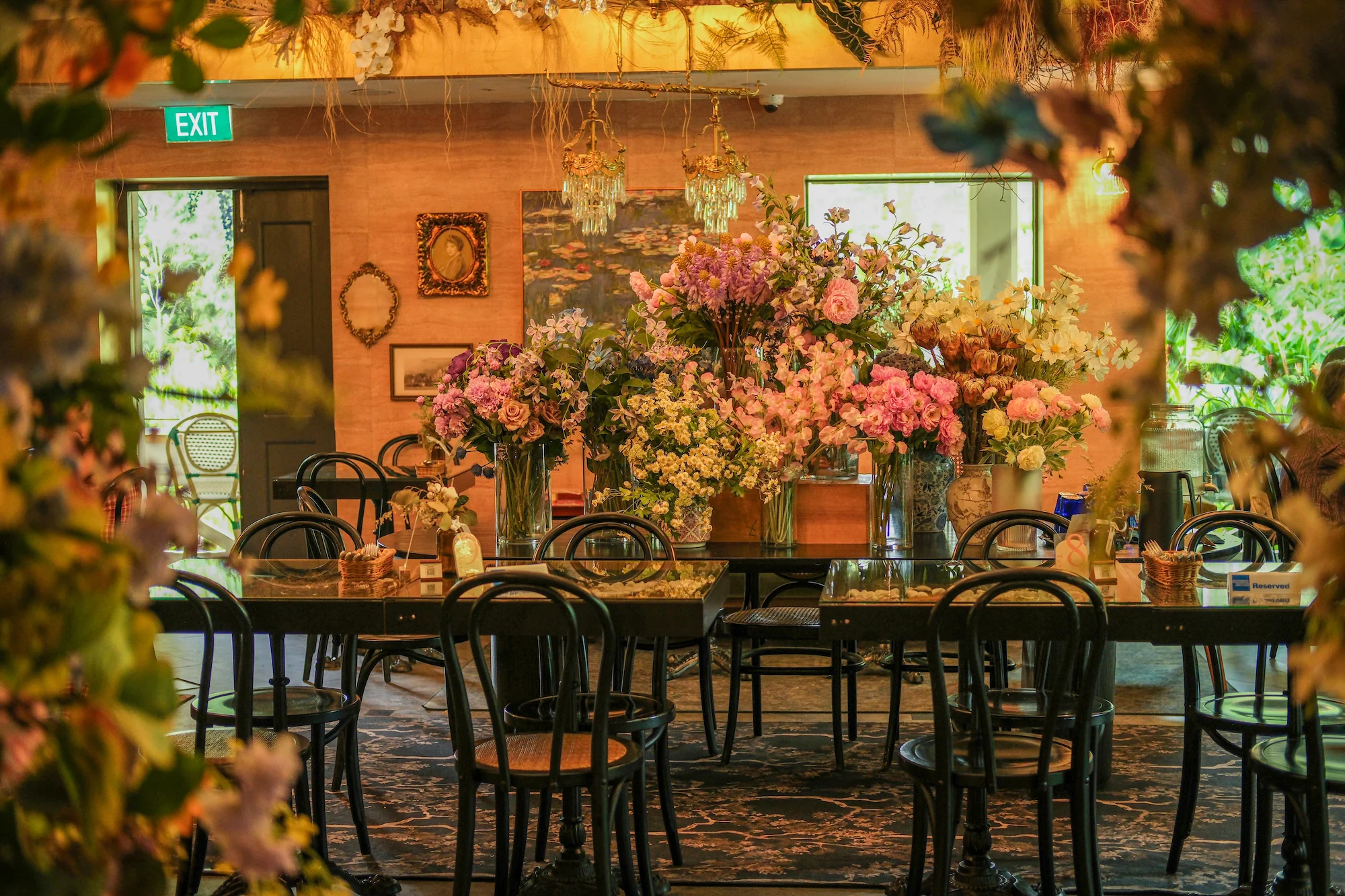 Le Jardin restaurant interior with warm lighting and lush floral decor
